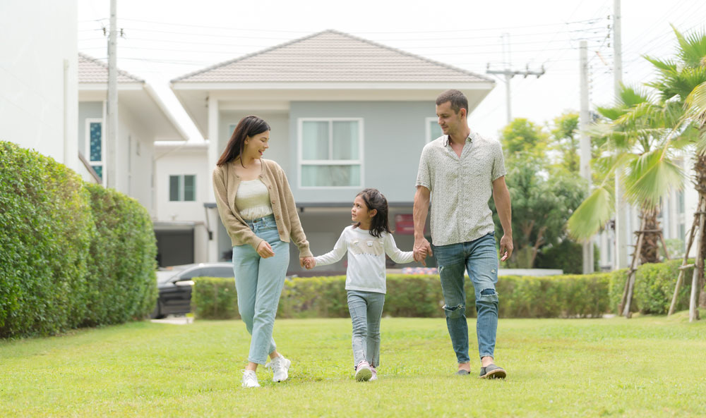 family in front of house