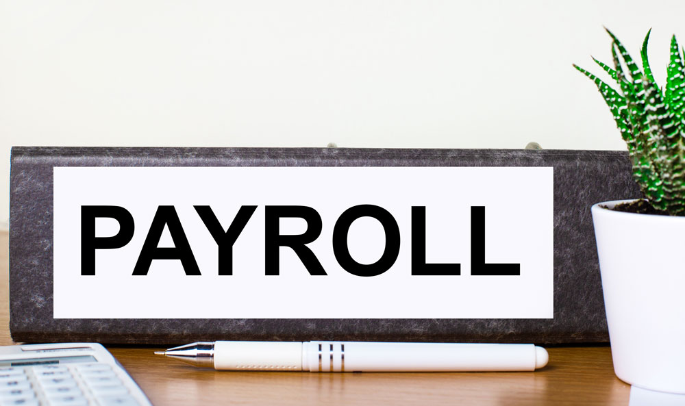 payroll placard on desk